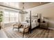 Bright bedroom with a four poster bed, neutral color palette, and large windows at Lot 11 Mayes Meadow Dr # Devonshire, Cornelius, NC 28078