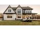 Beautiful two-story home boasting stone accents, a covered porch, and a professionally landscaped yard at Lot 11 Mayes Meadow Dr # Devonshire, Cornelius, NC 28078