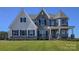 Attractive two-story home showcasing stone and siding, complemented by a lush green lawn at Lot 11 Mayes Meadow Dr # Devonshire, Cornelius, NC 28078