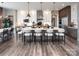 Modern kitchen features a large island with seating, wood floors, and stainless steel appliances at Lot 11 Mayes Meadow Dr # Devonshire, Cornelius, NC 28078