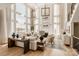 Elegant living room with soaring windows, fireplace, and stylish furnishings creating a bright, inviting space at Lot 11 Mayes Meadow Dr # Devonshire, Cornelius, NC 28078