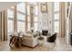 Elegant living room with soaring windows, fireplace, and stylish furnishings creating a bright, inviting space at Lot 11 Mayes Meadow Dr # Devonshire, Cornelius, NC 28078