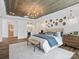 Comfortable primary bedroom with wooden ceiling, chandelier, and en-suite bathroom at Lot 11 Mayes Meadow Dr # Devonshire, Cornelius, NC 28078