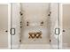 Double glass shower featuring dual shower heads and bench seating, plus recessed storage at Lot 11 Mayes Meadow Dr # Devonshire, Cornelius, NC 28078