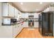 Bright eat-in kitchen with white cabinets, stainless steel appliances, and wood flooring at 1012 Rawlinson Rd, Rock Hill, SC 29732