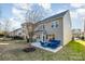 Backyard patio has seating, with a grill and lots of green space with view of the home's exterior at 10149 Elizabeth Crest Ln, Charlotte, NC 28277