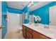 This bathroom has a double sink vanity and a shower/tub combination with bright blue walls and great lighting at 10149 Elizabeth Crest Ln, Charlotte, NC 28277