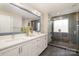 Bathroom with double vanity, large mirror, and frameless shower with glass door at 10149 Elizabeth Crest Ln, Charlotte, NC 28277