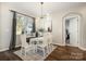 Inviting dining room features natural light, a stylish chandelier, and an elegant table setting at 10149 Elizabeth Crest Ln, Charlotte, NC 28277