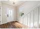 Welcoming entryway features a glass-paneled front door and a staircase with white railings at 10149 Elizabeth Crest Ln, Charlotte, NC 28277