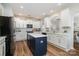 Well-lit kitchen features an island, stainless steel appliances, and stylish white cabinetry at 10149 Elizabeth Crest Ln, Charlotte, NC 28277