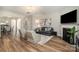 Living room features hardwood floors, a fireplace, modern décor, and a large window with natural light at 10149 Elizabeth Crest Ln, Charlotte, NC 28277