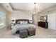 Serene main bedroom with natural light, stylish furniture, and tray ceiling with chandelier at 10149 Elizabeth Crest Ln, Charlotte, NC 28277