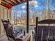 Back porch with rocking chairs overlooking trees and a body of water at 108 Three Oaks Ln, Kings Mountain, NC 28086