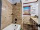 Bathroom features beige tiled walls and floor with a granite countertop and wooden cabinets at 108 Three Oaks Ln, Kings Mountain, NC 28086