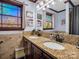 Bathroom with a double sink vanity, granite countertop, and multiple windows at 108 Three Oaks Ln, Kings Mountain, NC 28086