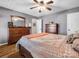 Cozy bedroom features hardwood floors, a ceiling fan, and two dressers for ample storage at 108 Three Oaks Ln, Kings Mountain, NC 28086