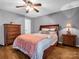 Bedroom with gray walls, hardwood floors, ceiling fan, and matching nightstand and dresser at 108 Three Oaks Ln, Kings Mountain, NC 28086