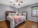 Bedroom features a large mirror, hardwood floors, a ceiling fan, and a window at 108 Three Oaks Ln, Kings Mountain, NC 28086