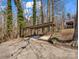 Carport with cement floor is surrounded by a wooded area at 108 Three Oaks Ln, Kings Mountain, NC 28086