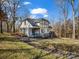 Two story home featuring a covered front porch, American flag, and winter landscaping at 108 Three Oaks Ln, Kings Mountain, NC 28086