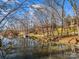 Picturesque lakeside home with a private dock, surrounded by trees and reflected in the water at 108 Three Oaks Ln, Kings Mountain, NC 28086