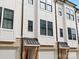 Modern townhome exterior with white siding, dark windows, and metal awnings at 1122 Pegram Crossing Dr, Charlotte, NC 28205