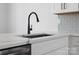 Modern kitchen sink with a black faucet and white quartz countertop at 1122 Pegram Crossing Dr, Charlotte, NC 28205