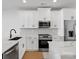 Modern kitchen featuring white cabinets, stainless steel appliances, and quartz countertops at 1122 Pegram Crossing Dr, Charlotte, NC 28205