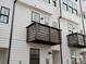 Close-up view of townhome balconies and white siding at 1122 Pegram Crossing Dr, Charlotte, NC 28205