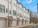 Row of modern townhomes with attached garages and street view at 1122 Pegram Crossing Dr, Charlotte, NC 28205