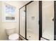 Bathroom featuring a toilet next to a glass shower enclosure with white subway tile and a window at 1135 Rudder Cir, Salisbury, NC 28146