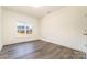 Bedroom featuring hardwood floors, a large window, white walls, and white trim at 1135 Rudder Cir, Salisbury, NC 28146