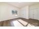 Bedroom featuring wood flooring, a large window, white walls, and a double door closet at 1135 Rudder Cir, Salisbury, NC 28146