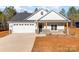 Craftsman style home with gray siding, stone accents, and a two-car garage at 1135 Rudder Cir, Salisbury, NC 28146