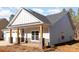 Angled view of single-story house with stone accents and timber columns supporting covered porch at 1135 Rudder Cir, Salisbury, NC 28146