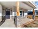 Inviting front porch with stone accents, a dark front door, and rustic column with house numbers at 1135 Rudder Cir, Salisbury, NC 28146