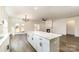 Modern kitchen island with granite countertops that overlooks the adjacent living room and dining area at 1135 Rudder Cir, Salisbury, NC 28146