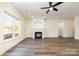 Spacious living room with wood-look floors, fireplace, and large window with outdoor views at 1135 Rudder Cir, Salisbury, NC 28146