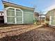 Two green sheds in a sunny backyard at 12 Maple St, Great Falls, SC 29055