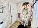 Updated bathroom with pedestal sink and floral wallpaper at 12 Maple St, Great Falls, SC 29055