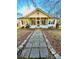 Charming house with a stone walkway and a porch at 12 Maple St, Great Falls, SC 29055