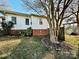 Back of house with brick foundation and landscaping at 12 Maple St, Great Falls, SC 29055