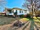 Side view of a charming ranch home with mature trees at 12 Maple St, Great Falls, SC 29055