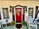 Red front door with lanterns and floral decor at 12 Maple St, Great Falls, SC 29055