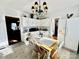 Bright kitchen with white cabinets, tiled floor, and a dining table at 12 Maple St, Great Falls, SC 29055