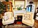 Cozy living room with fireplace and two armchairs, hardwood floors and decorative accents at 12 Maple St, Great Falls, SC 29055