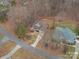 An aerial view of the home showcases the surrounding neighborhood and the wooded lot at 122 Ardmore Pl, Mooresville, NC 28117