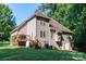 Expansive home backyard with a wooden deck, lush lawn and mature trees in a peaceful setting at 122 Ardmore Pl, Mooresville, NC 28117