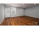 Finished basement featuring wood laminate floors, a window, and walkout door at 122 Ardmore Pl, Mooresville, NC 28117